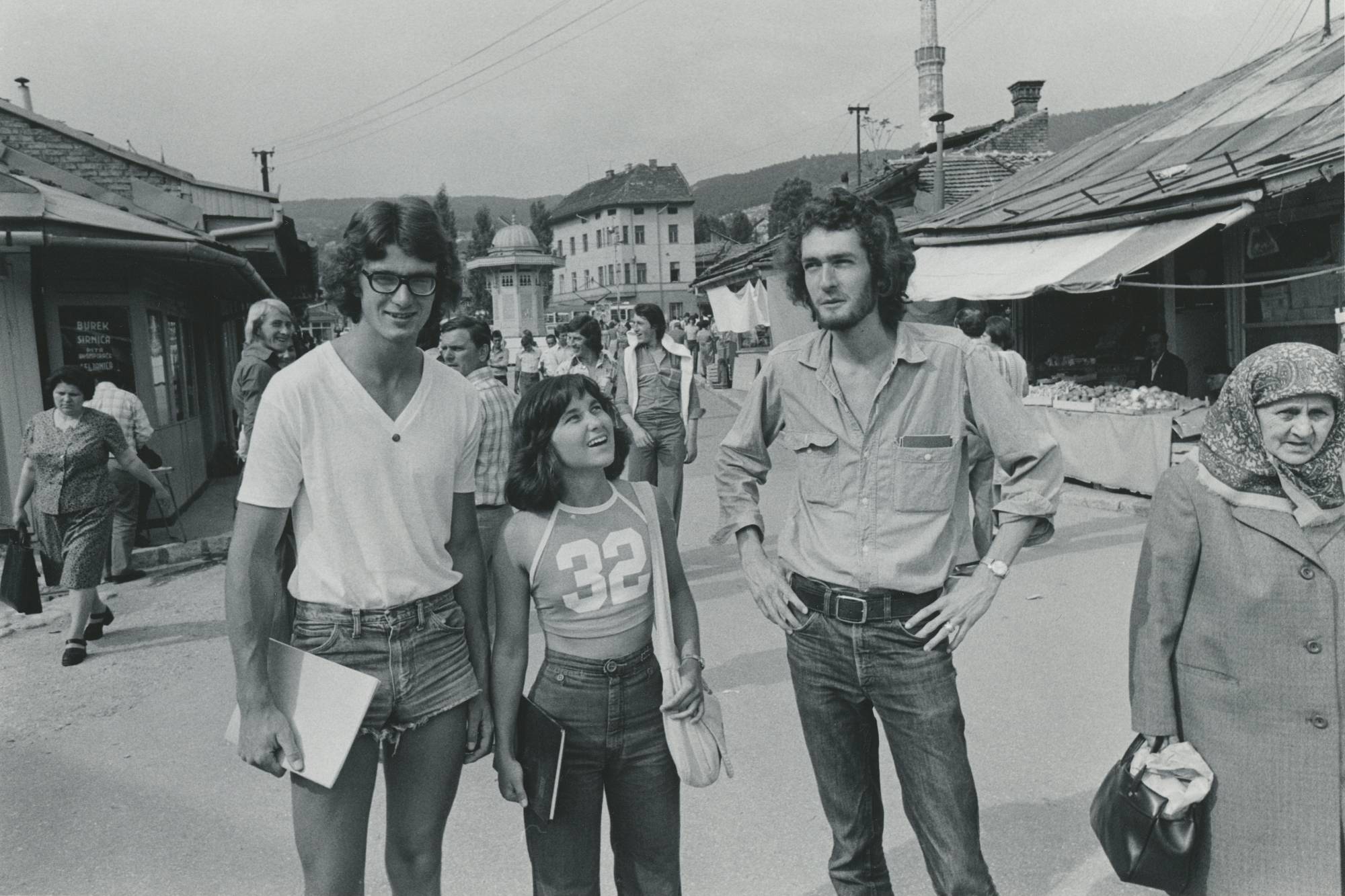 black and white photograph of font of holy water next to column